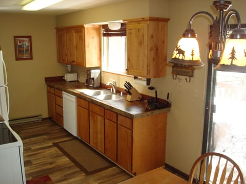 The roomy kitchen has direct access to the deck, gas BBQ grill and fire pit.