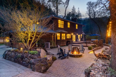Creekside back patio and deck with fire pit, outdoor seating, dining and hot tub