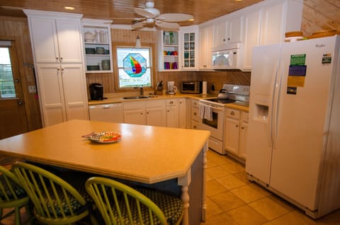 Large Kitchen island for serving, extra seating on three counter stools.
