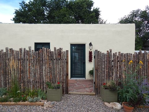 Gated entry to private fenced courtyard.