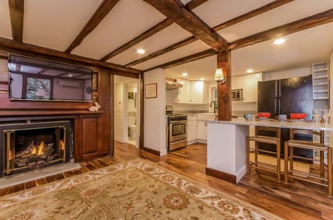 Living room has gas fireplace, 44" TV & large dining/work table with chairs. 