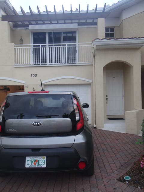 front door below 2nd balcony off of second bdrm