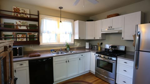 gas range, DW, microwave, granite tops, lots of light, oak floor