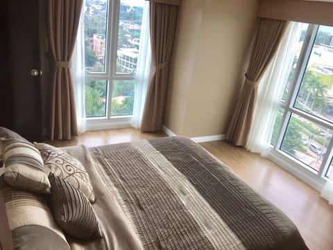 Bedroom with floor to ceiling windows.