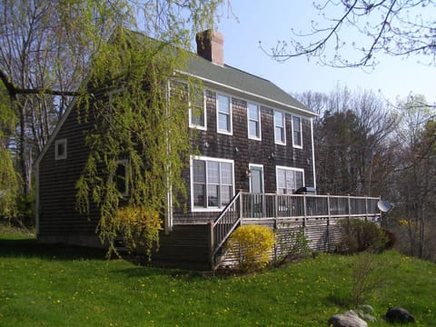 Front of the house with deck and gas grill