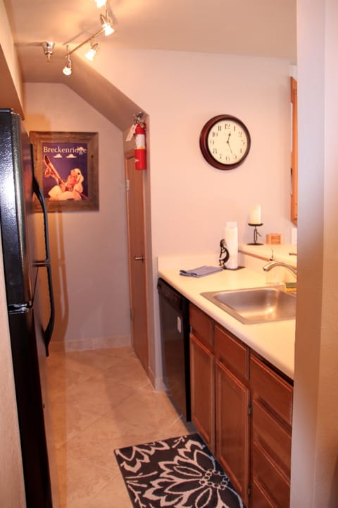 Kitchen includes plates, K - cup coffee maker,  and cooking needs.