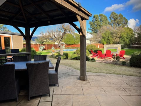 New pergola added 2022, seating for 8, cabana at left, pool & outdoor fireplace