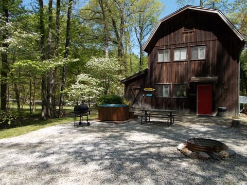 Cabin AB outside parking area with hot tub and fire pit.