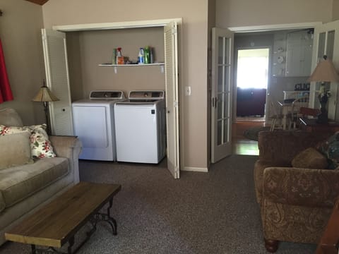 Back room and entrance to The Cottage, has a  washer and dryer. 