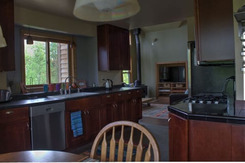 View from kitchen table (6 chairs/2 stools) into living room.