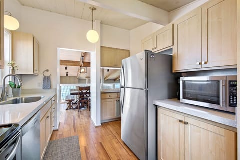 Remodeled kitchen opens to main living areas and BBQ deck. Ocean all around.