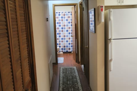 Hallway from kitchen toward downstairs bathroom and bedroom