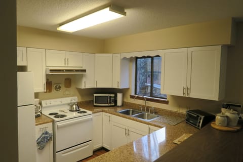 lots of kitchen workspace and a breakfast bar for four
