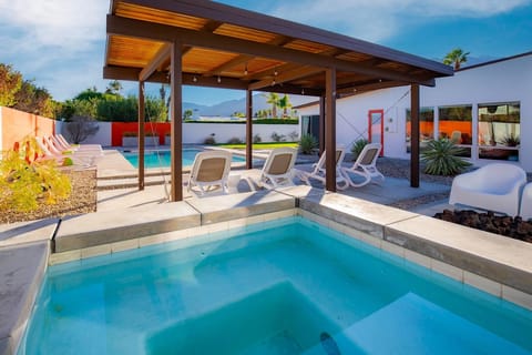 Hot tub situated by the gas firepit and pergola