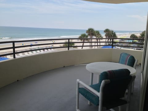 Balcony overlooking ocean and pool deck.