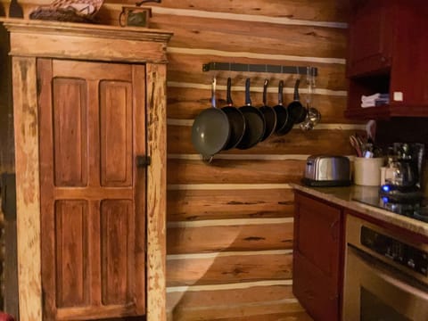 Kitchen is fully stocked with pots, pans, spices, and other pantry essentials.