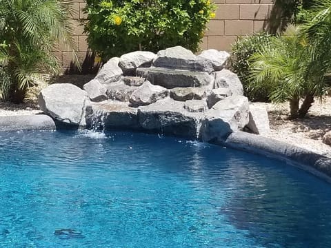 Pool with soothing waterfall, just newly resurfaced in a beautiful blue!