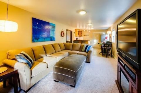 Lower level living area with sectional and TV.