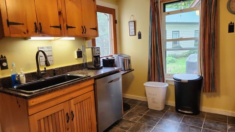 The kitchen with a farm sink and dishwasher