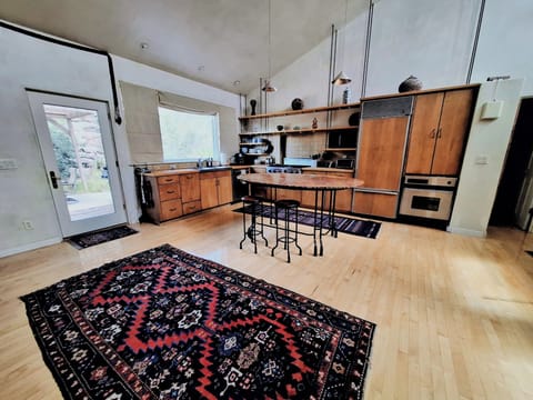 Kitchen with new oven, stainless steel dishwasher, and large gas range stovetop
