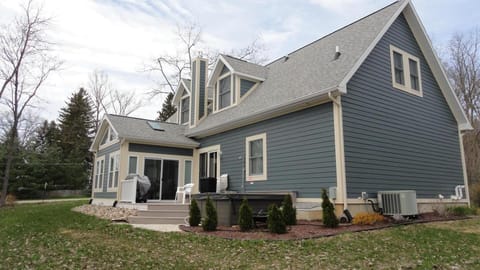 Rear View - Outdoor deck, hot tub, outdoor shower and gas barbecue grill.