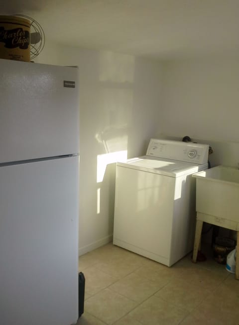 Laundry room with washer & dryer and side entrance for easy clean ups.