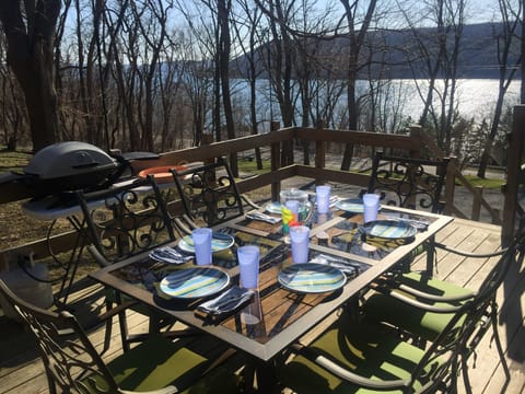 Outdoor table with grill in side porch. What a view!