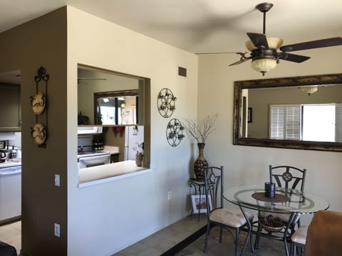 The inside dining room with a window opening into the kitchen!