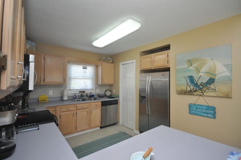 Stainless steel appliances and pantry for storage.

