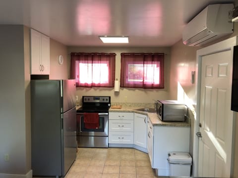 The Cabana Kitchen: Fridge, Stove, Microwave and dishes