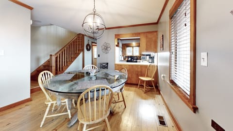 Dining area featuring authentic grist mill repurposed to a unique dining table.
