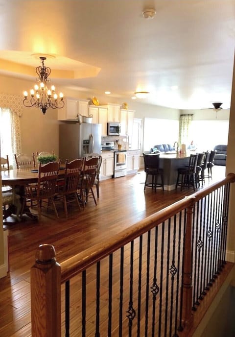Main floor dining kitchen area with additional seating at the bar well stocked 