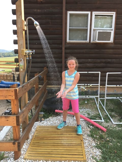 Clean-up after swimming with convenient outdoor shower with hot and cold water