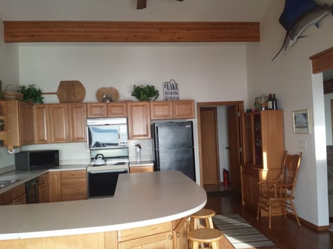 View of wrap around counter that seats 8 on bar stools in Kitchen