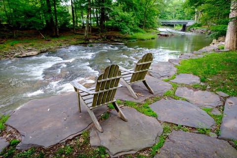 Adairondack Chairs on Stone Patio Stream Side 