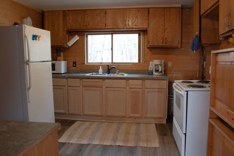 kitchen with fridge, range, microwave, mixer, coffee maker and more