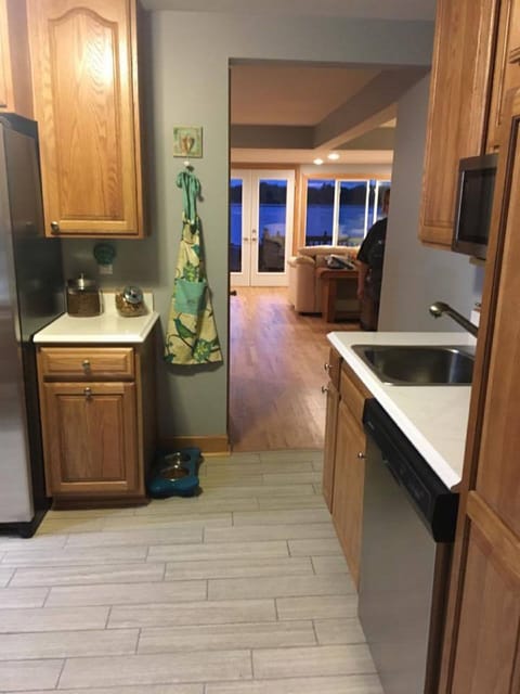 From the back of the house looking into the open living/dining area & lake