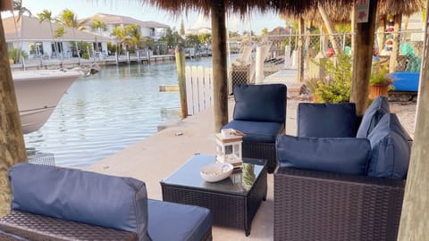 Canal front seating under covered tiki- no boat dockage.