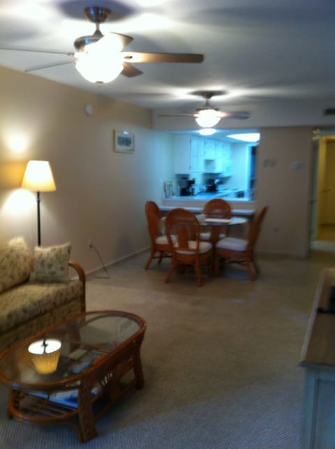 Open layout Living Room to Dining Room featuring textured ceilings and duel fans
