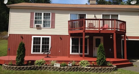 Our mountain house showing downstairs and upstairs front decks and garage