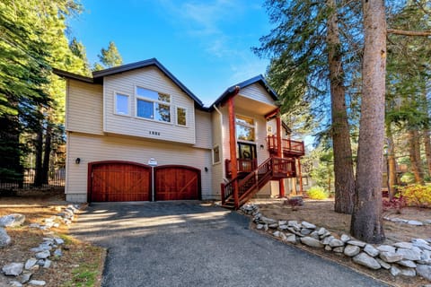 Charming mountain retreat nestled among towering pines with warm wood details and spacious garage for your outdoor gear.