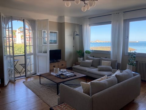 Living room with sea view and port view and balcony