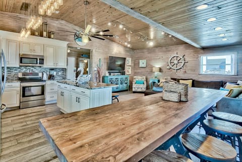 Fully equipped kitchen w/ ample counter space and a welcoming coastal feel.