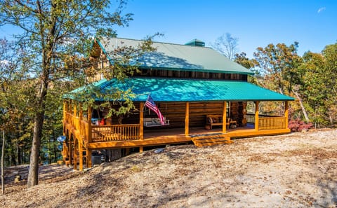 Beautiful rustic log cabin design with a full wraparound porch.