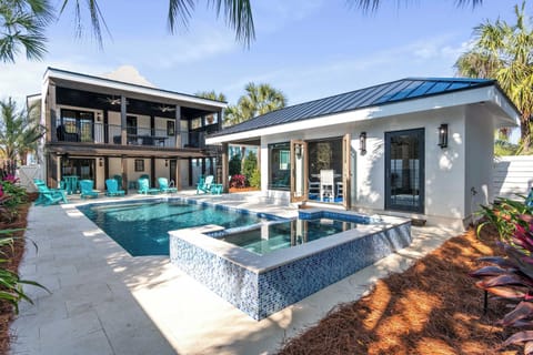 Courtyard-style pool & spa framed by modern architecture & palms.