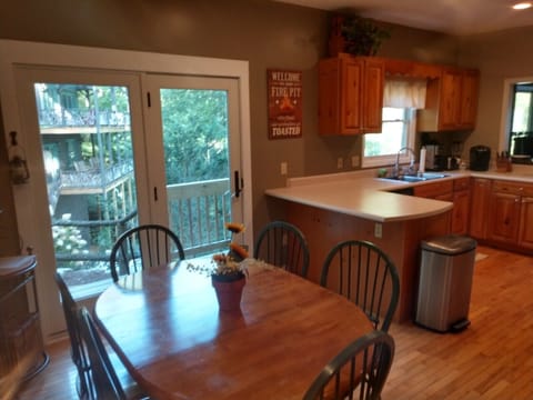 Main Level Kitchen with side access to Grill, Firepit and stone steps to Dock