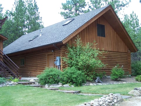 Outside of garage with apartment in upper floor.