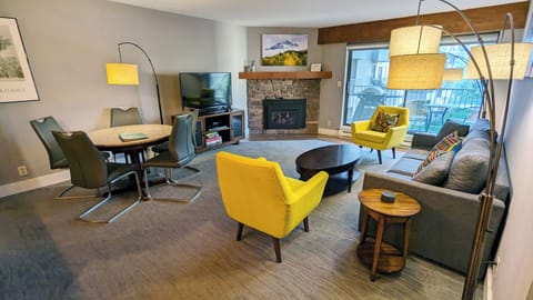 Living room with gas fireplace, dining table, and balcony w/ gas BBQ