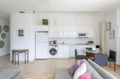 Kitchen with refrigerator, dishwasher, microwave, cooktop, coffee maker