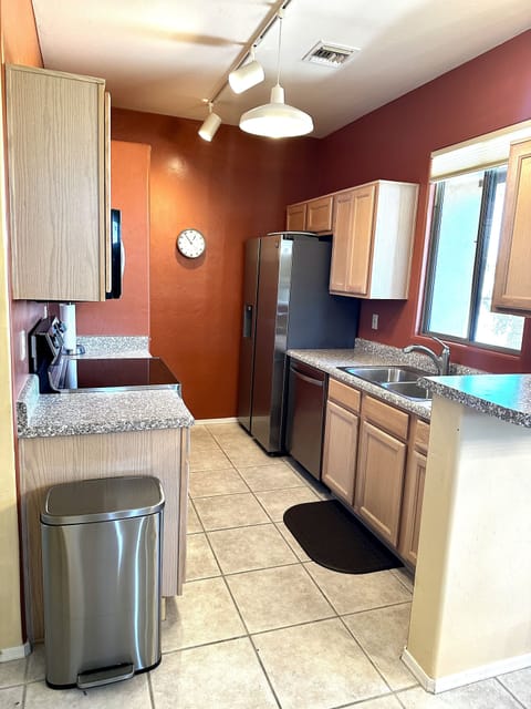 Galley kitchen with new appliances and views of the mountains